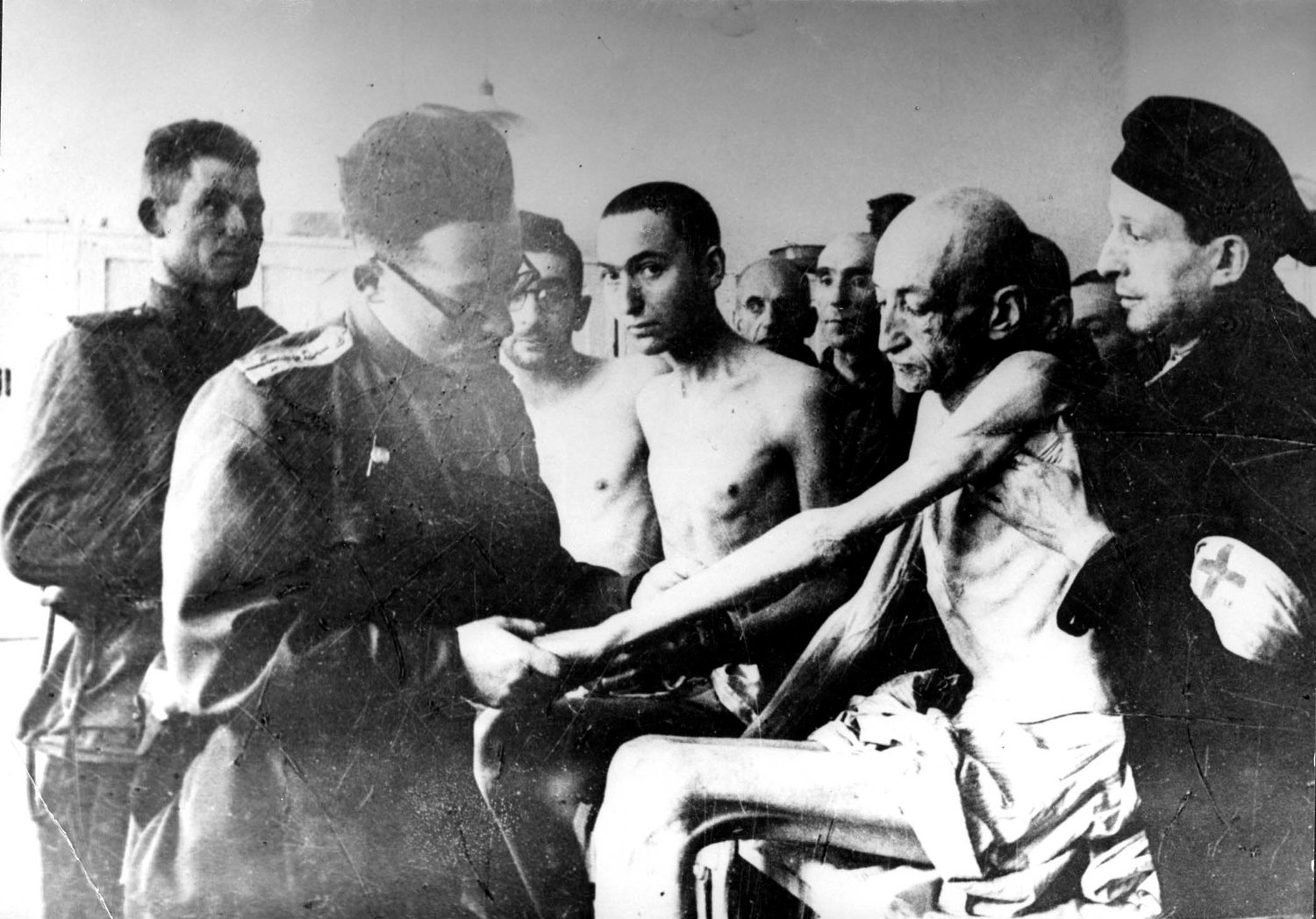 A Russian military doctor examines Holocaust survivors after the liberation of the Nazi death camp Auschwitz-Birkenau in 1945 in Oswiecim, Poland. Historians estimate that the Nazis sent at least 1.3 million people to Auschwitz between 1940-45, and it is believed that some 1.1 million of those perished there. Auschwitz was liberated by the Russian Army Jan. 27, 1945.